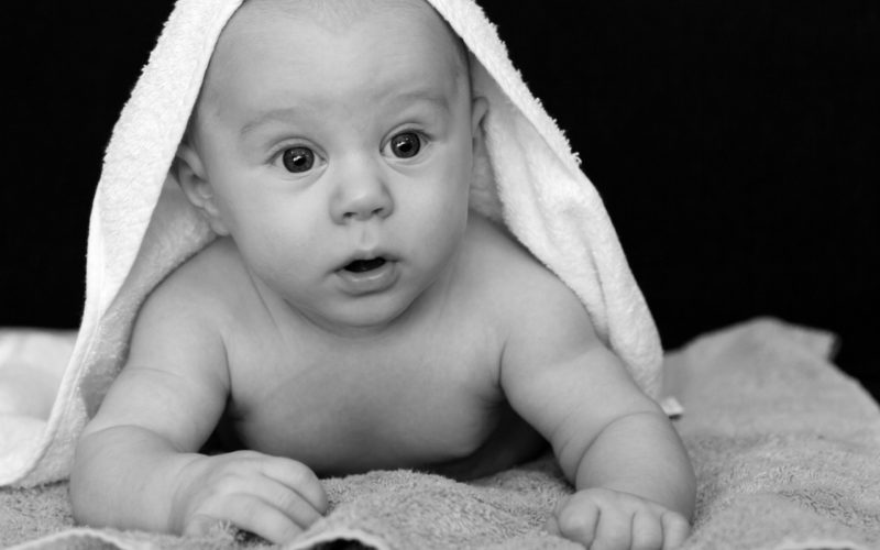 baby-covered-by-white-towel-grayscale-photography-2